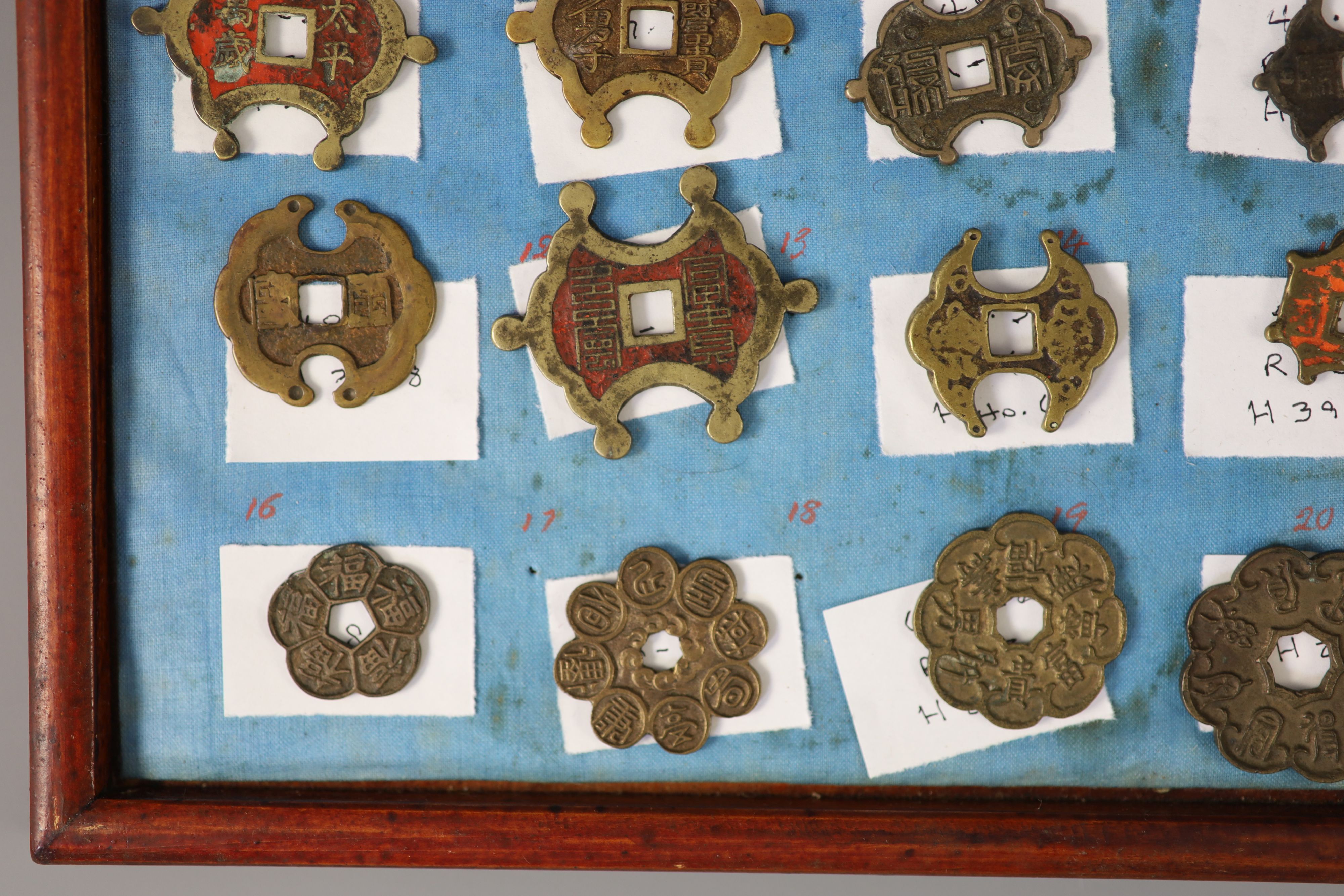 A group of 99 Korean bronze and metal amulets or charms, 19th/20th century